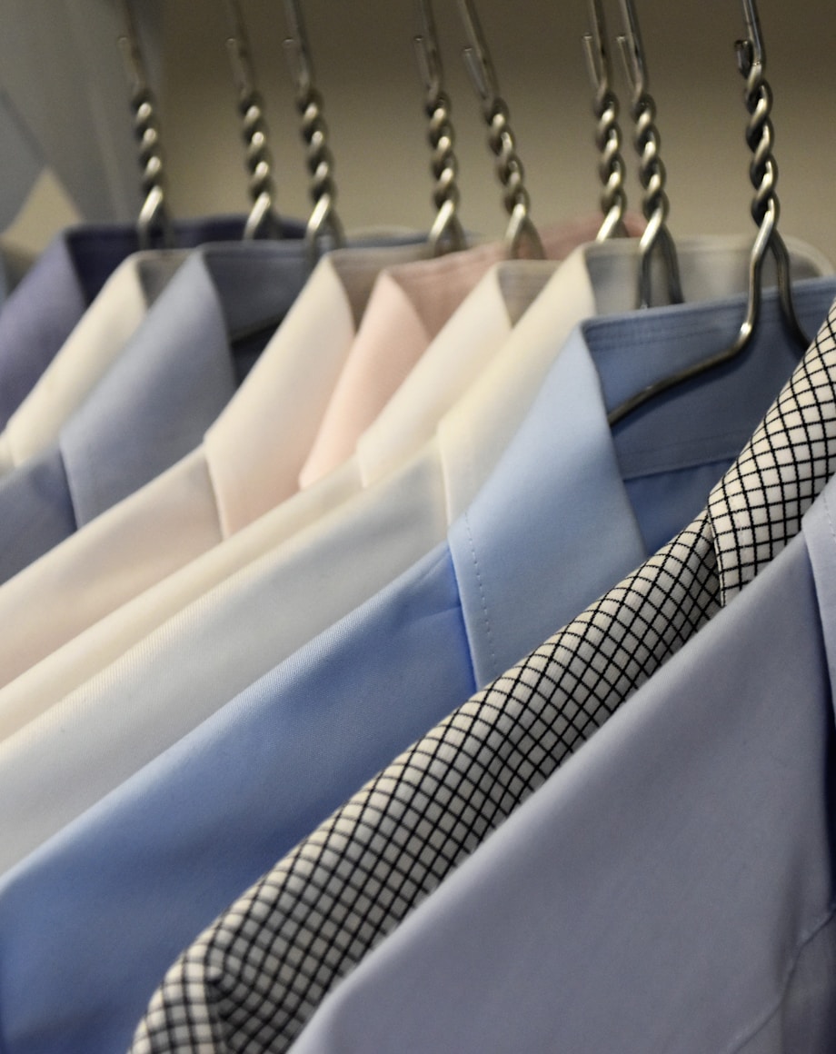 Assorted formal suit jackets on a garment rail