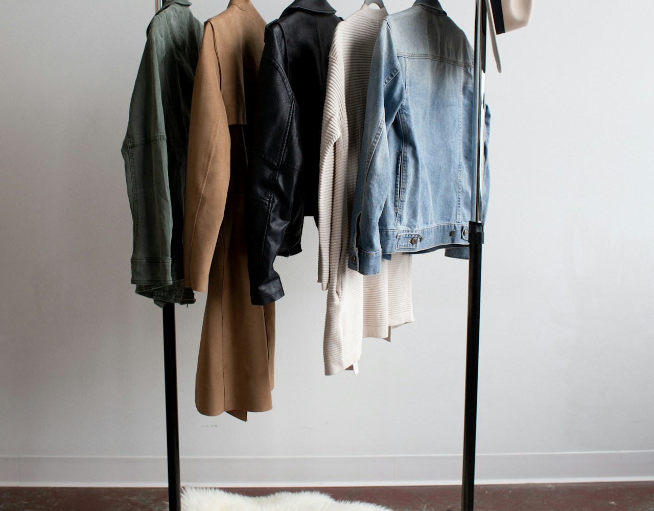 Five jackets hanging neatly on a clothes rail
